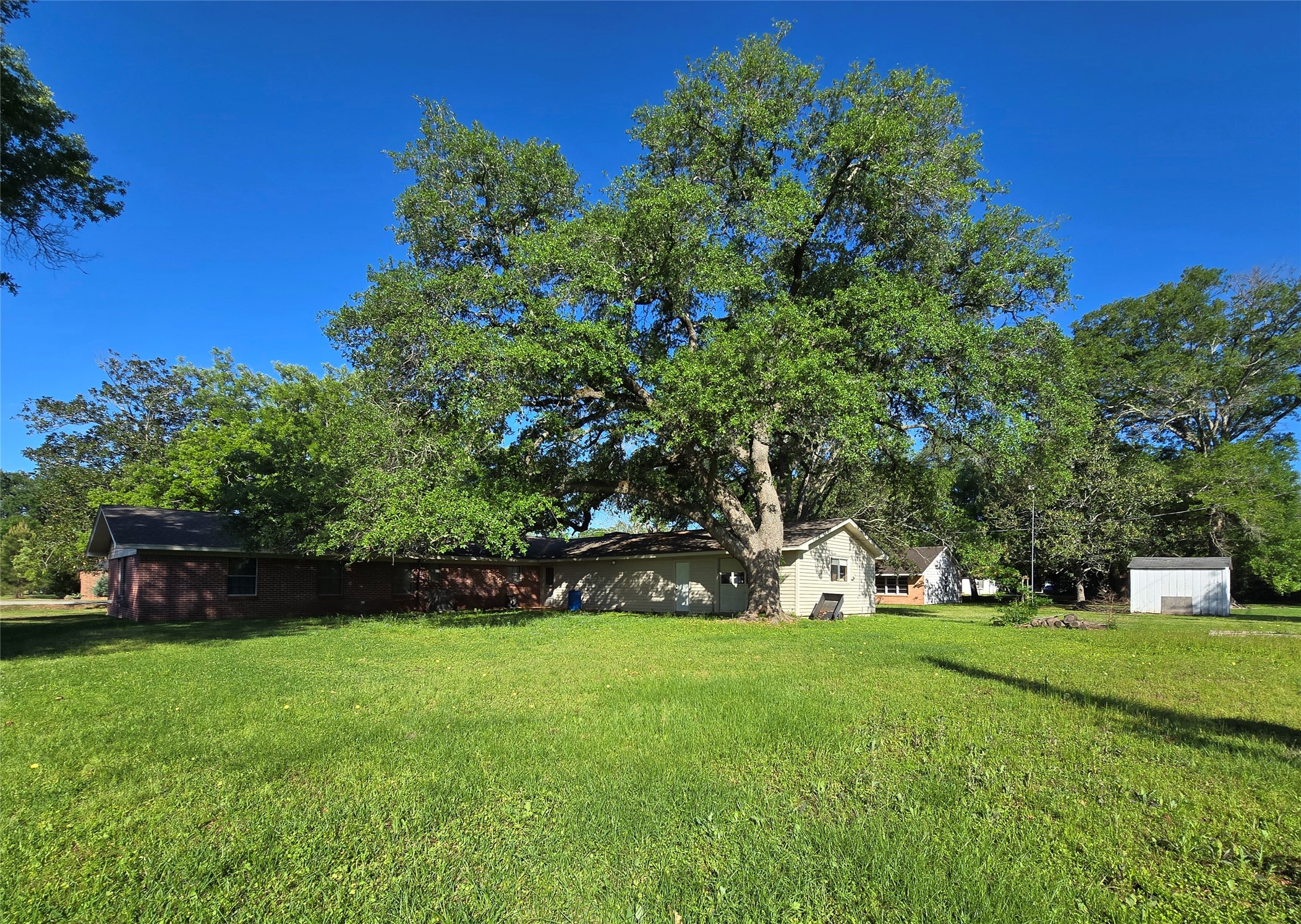 607 South Main Street Dayton, TX 77535 - Photo 34 of 39 a view of green field with tree in the background