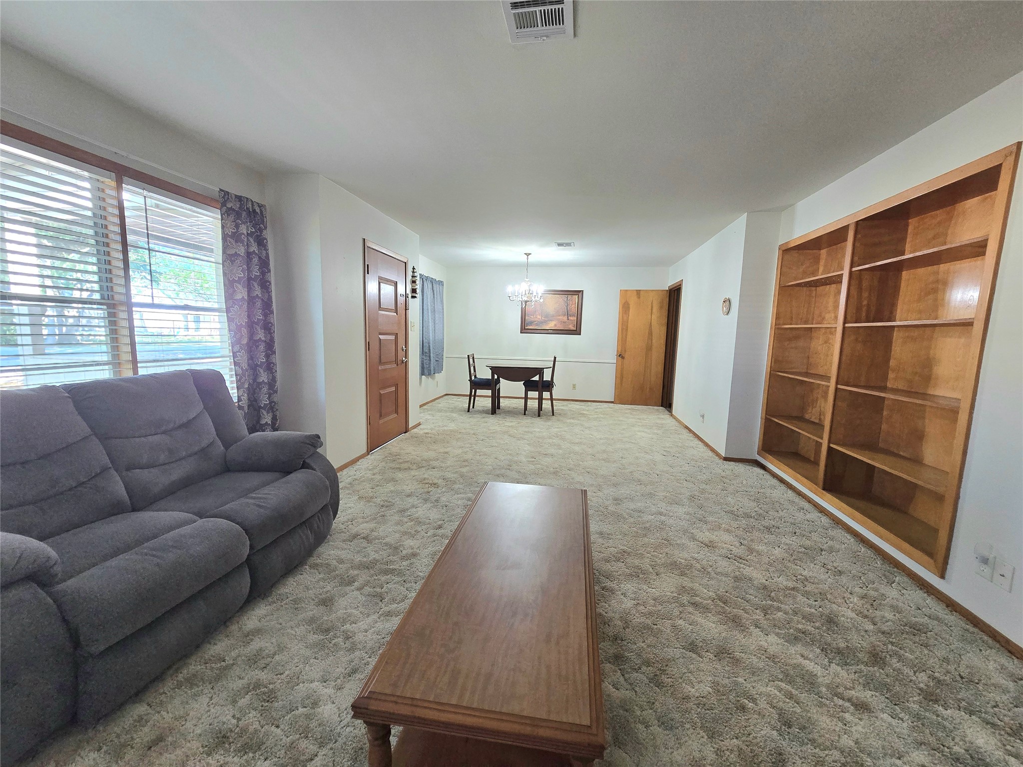 607 South Main Street Dayton, TX 77535 - Photo 5 of 39 a living room with furniture and a large window