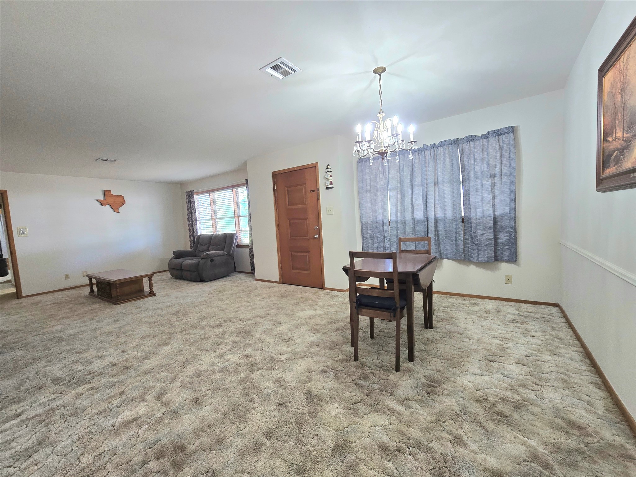 607 South Main Street Dayton, TX 77535 - Photo 7 of 39 a living room with furniture and a chandelier