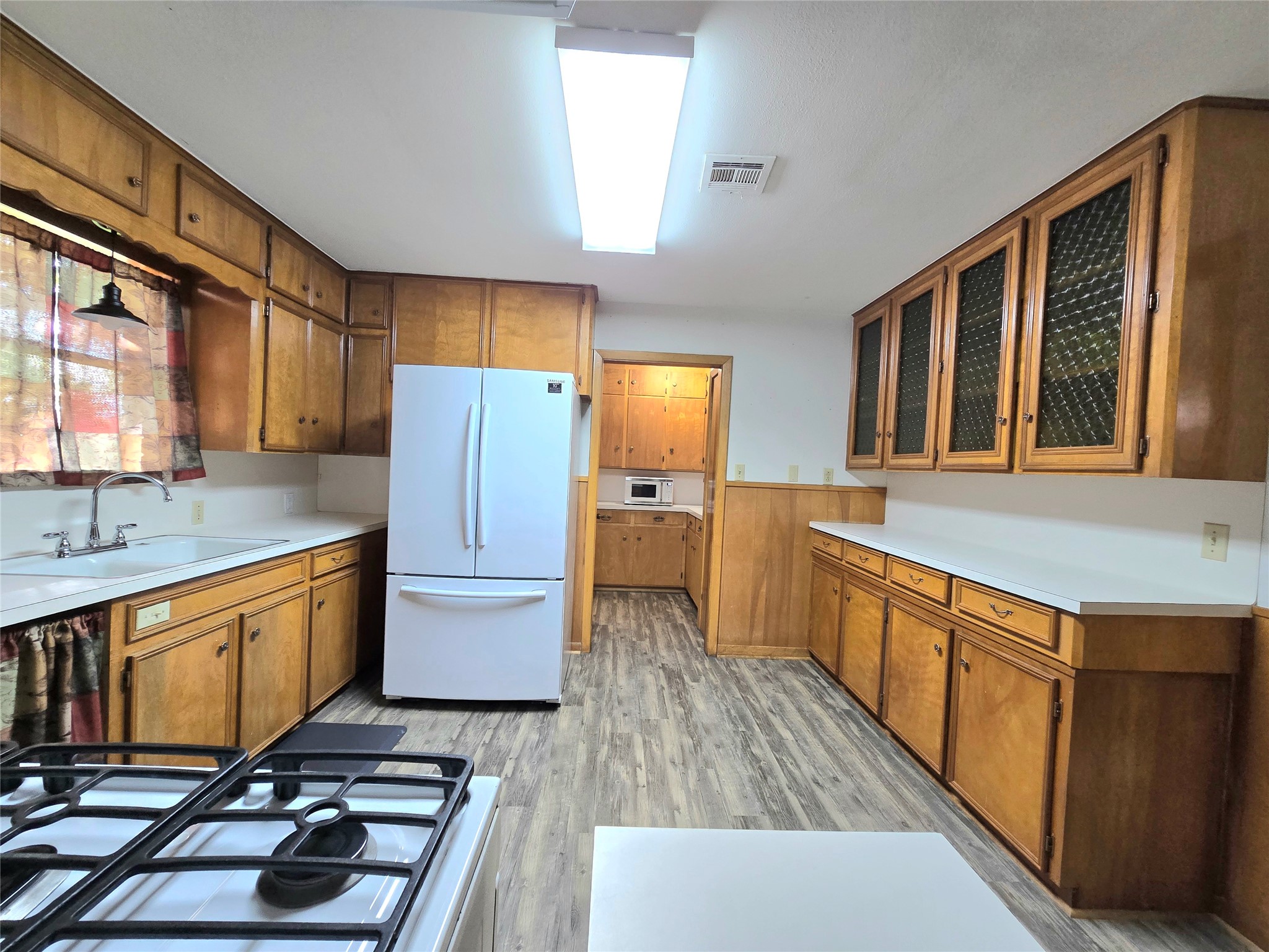 607 South Main Street Dayton, TX 77535 - Photo 10 of 39 a kitchen with stainless steel appliances a stove a sink and a refrigerator