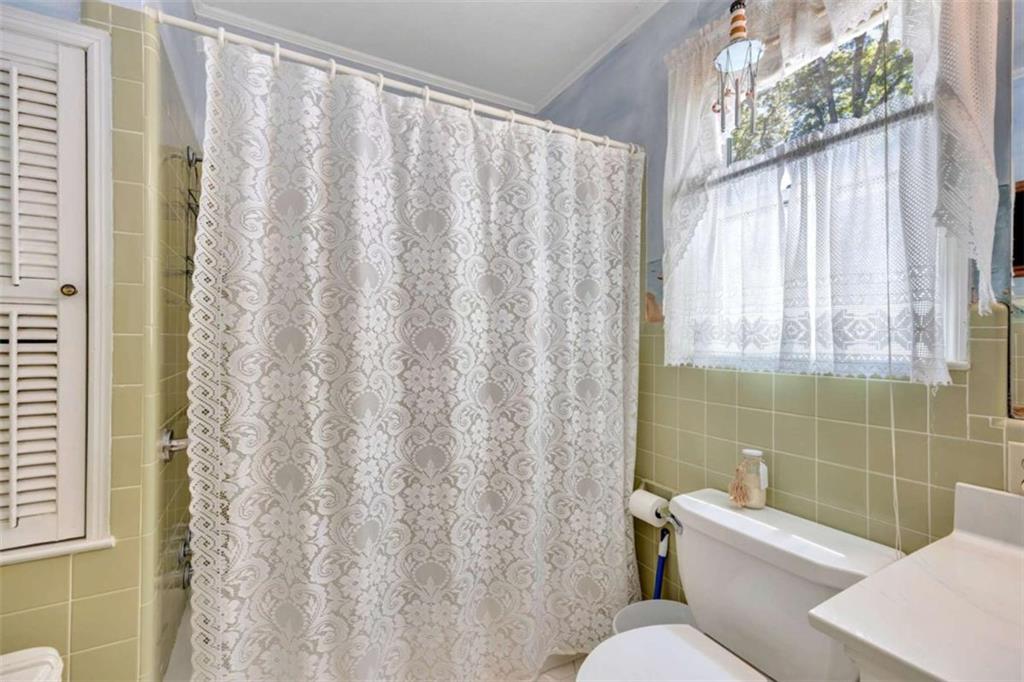 103 Gabriel Way Social Circle, GA 30025 - Photo 47 of 70 a white toilet sitting next to a shower curtain