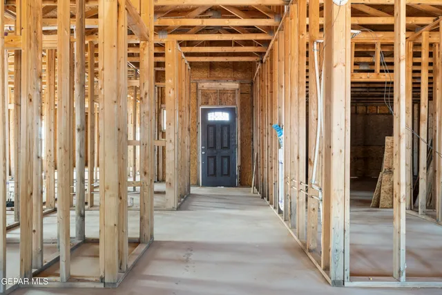 a view of a hallway with wooden floor and glass door