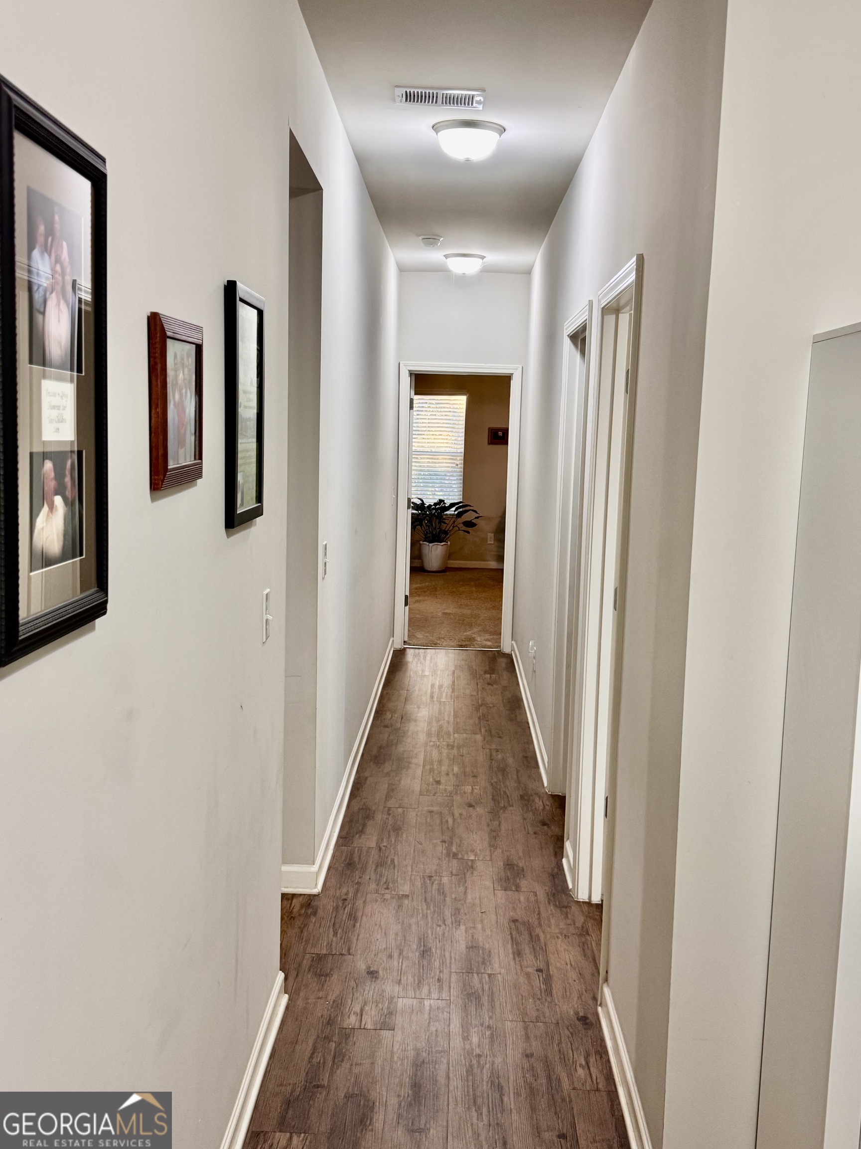 52 Pulaski Avenue Hampton, GA 30228 - Photo 14 of 32 a view of a hallway with wooden floor and closet