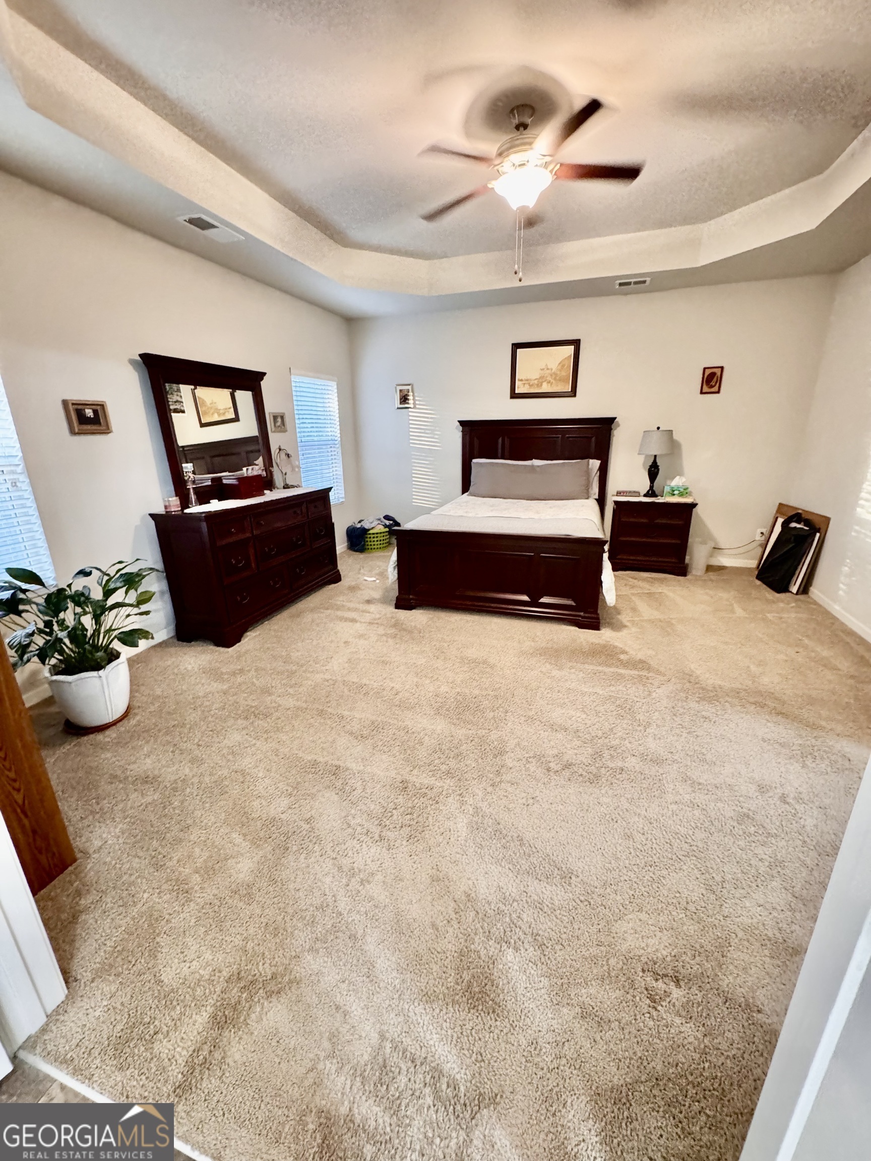 52 Pulaski Avenue Hampton, GA 30228 - Photo 18 of 32 a bedroom with a bed and a chandelier