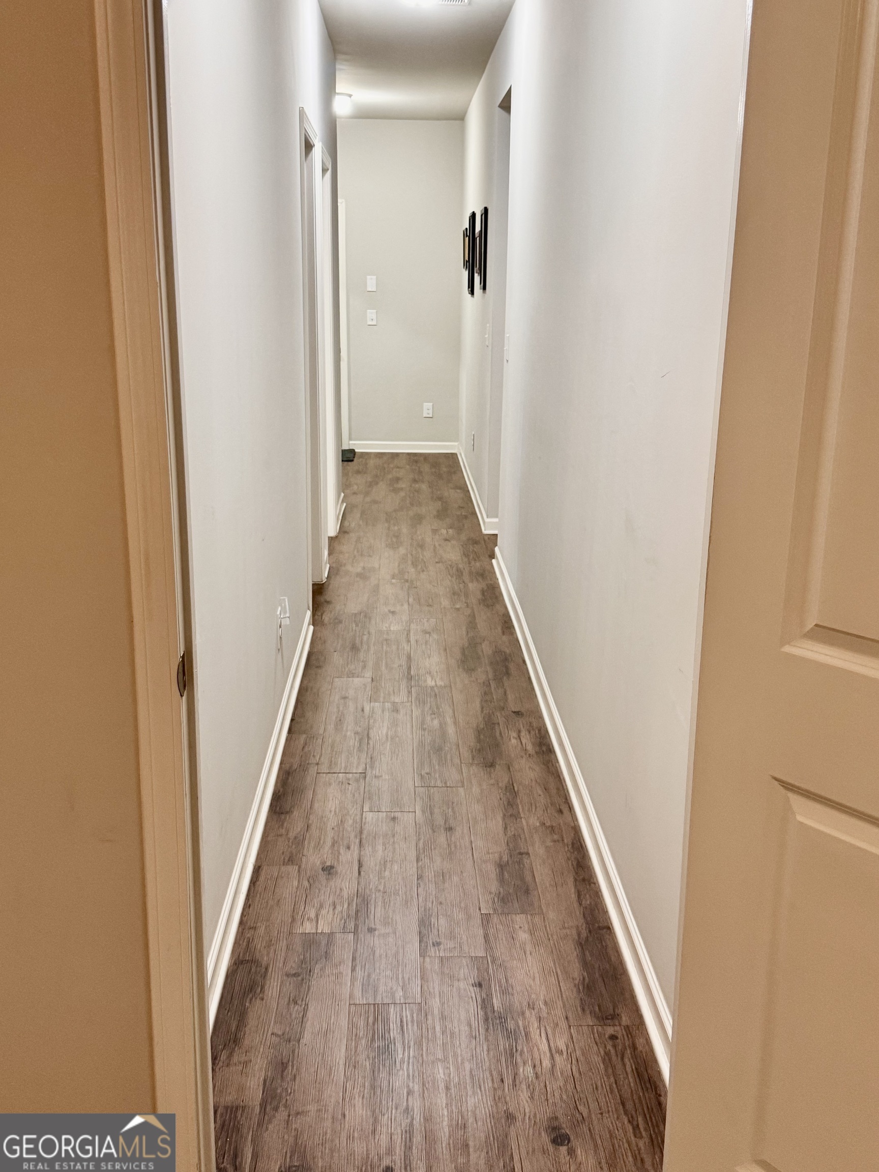 52 Pulaski Avenue Hampton, GA 30228 - Photo 25 of 32 a view of a hallway with wooden floor and staircase