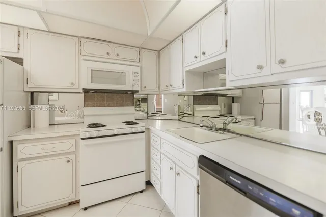 a kitchen with appliances cabinets and a sink