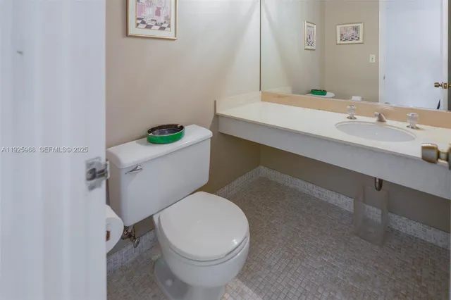 a white toilet sitting next to a bathroom sink