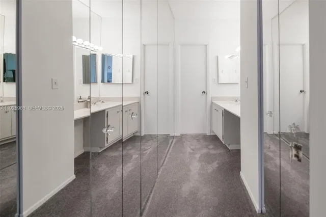 a bathroom with a granite countertop sink and mirror