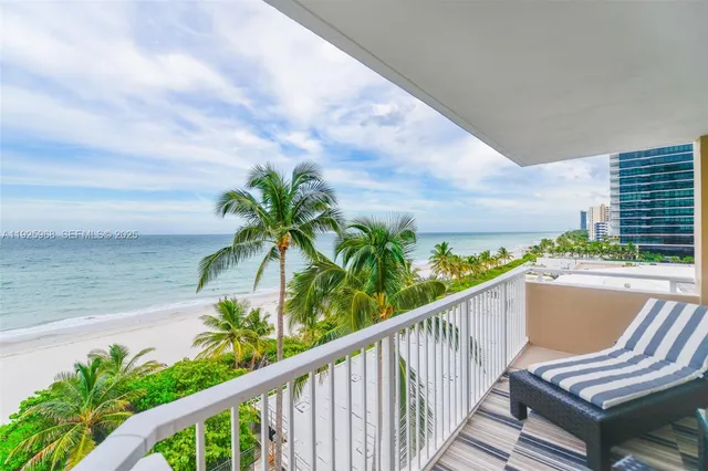 a view of balcony with wooden floor and seating space