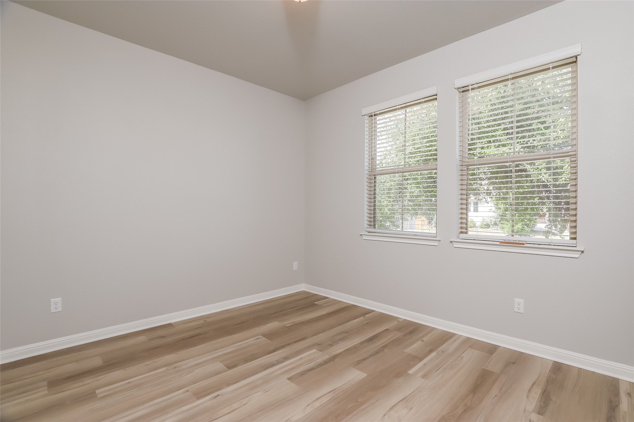 2724 Juniper Woods Road Leander, TX 78641 - Photo 13 of 21 A well-lit room featuring light wood flooring, perfect for a cozy bedroom or versatile office space.