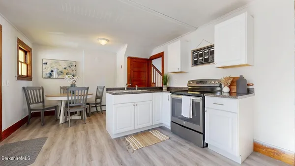 a kitchen with stainless steel appliances a stove a sink dishwasher and a refrigerator