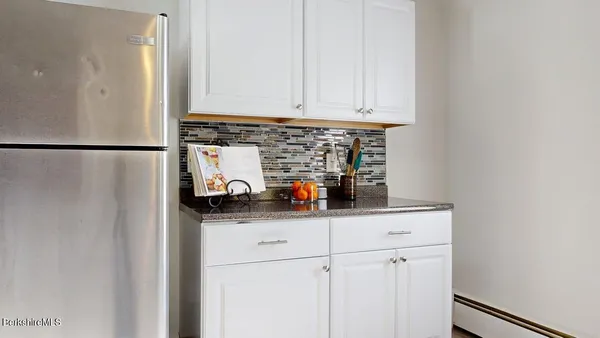 a kitchen with stainless steel appliances a refrigerator and cabinets
