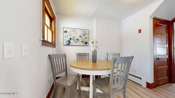 a view of a dining room with furniture and window