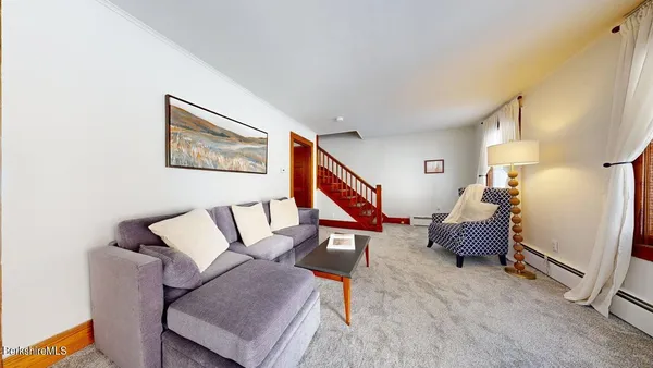 a living room with furniture and a rug