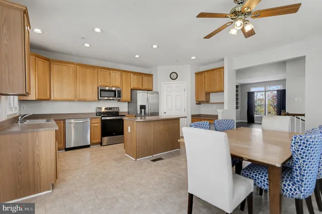 a kitchen with a table chairs microwave and cabinets