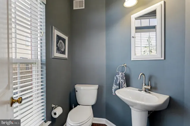 a bathroom with a sink toilet and a mirror