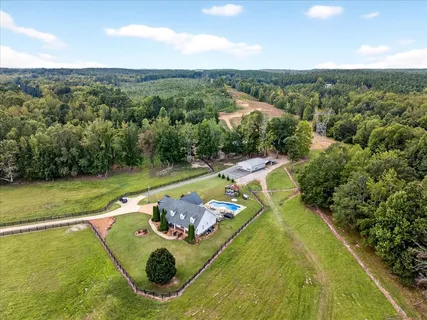an aerial view of a house with a swimming pool