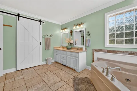 a bathroom with a toilet a sink and a large mirror