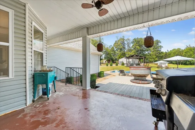 a view of a patio with swimming pool table and chairs