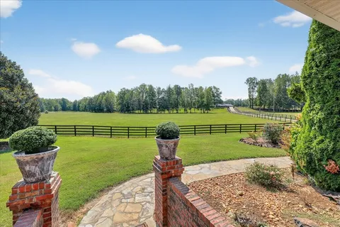 a view of an house with backyard space and garden
