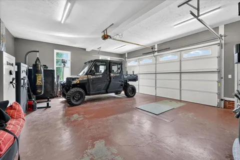 a view of a house with a patio and a yard