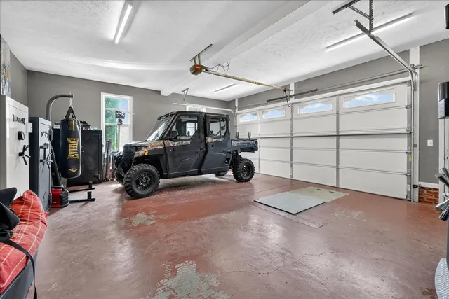 a view of a house with a patio and a yard