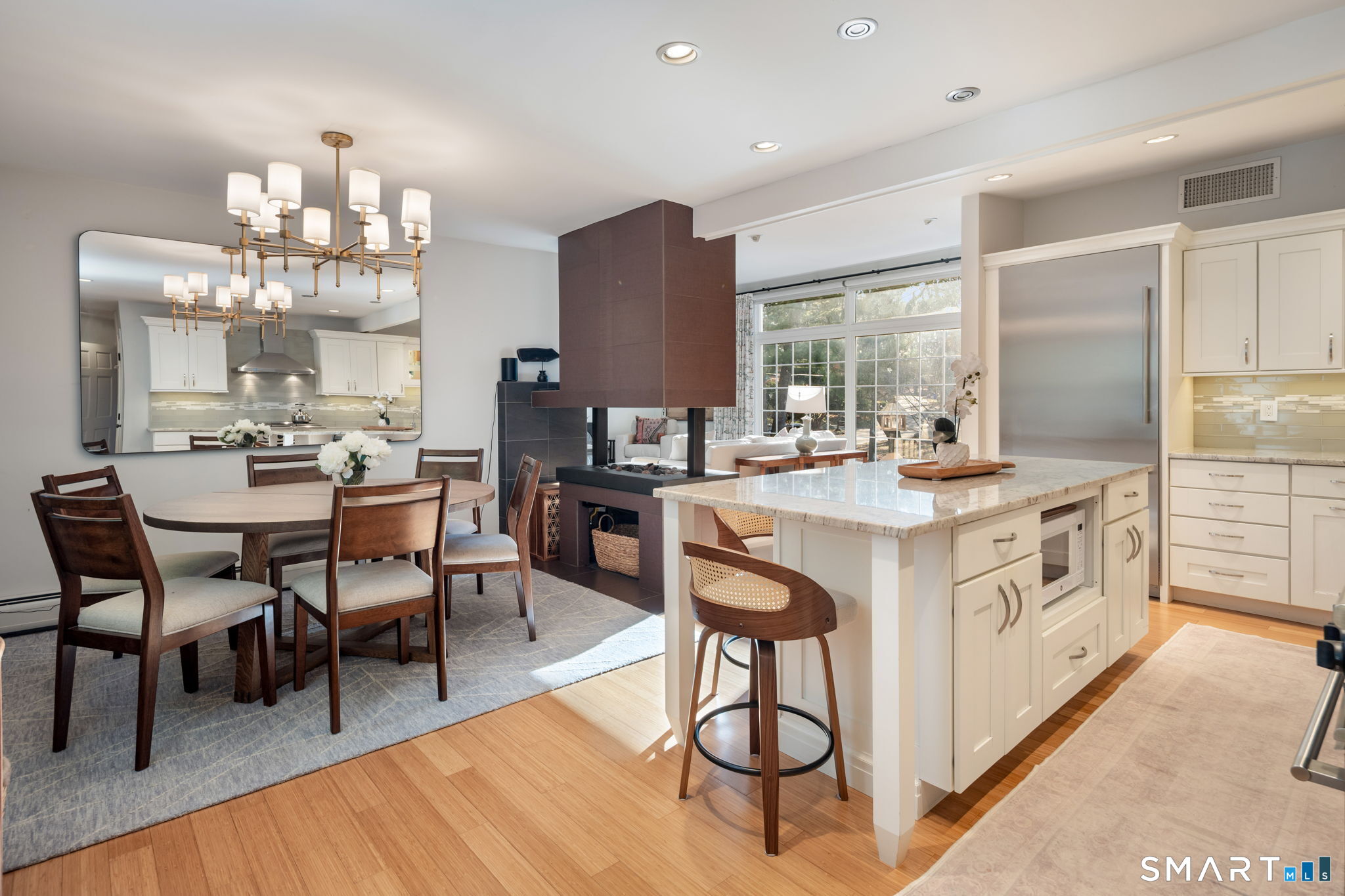 12 Splitrock Road Norwalk, CT 06854 - Photo 11 of 37 a kitchen with stainless steel appliances a dining table wooden floor and a view of living room