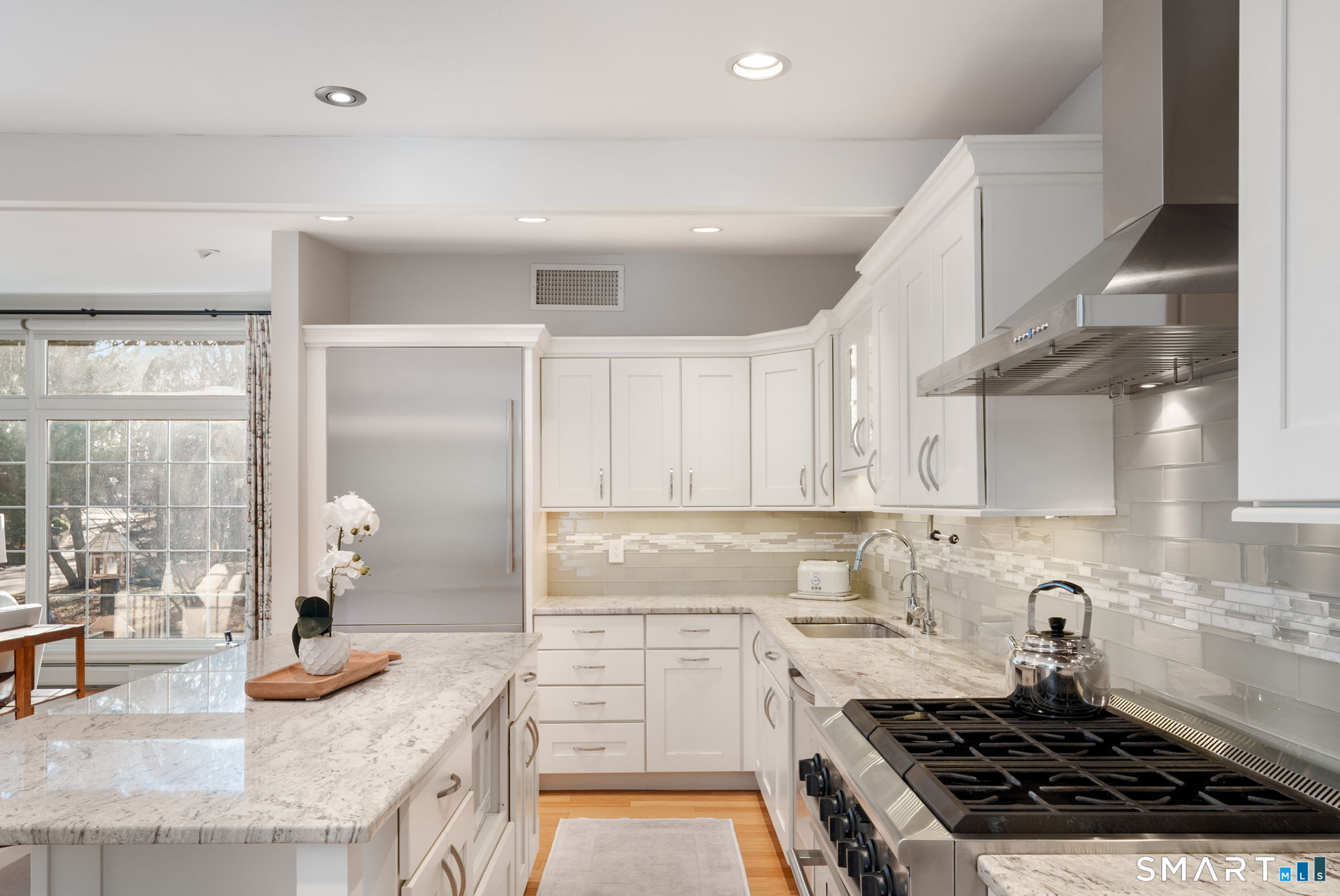 12 Splitrock Road Norwalk, CT 06854 - Photo 12 of 37 a kitchen with granite countertop stainless steel appliances stove a sink and cabinets