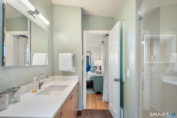 a bathroom with a toilet a sink and mirror