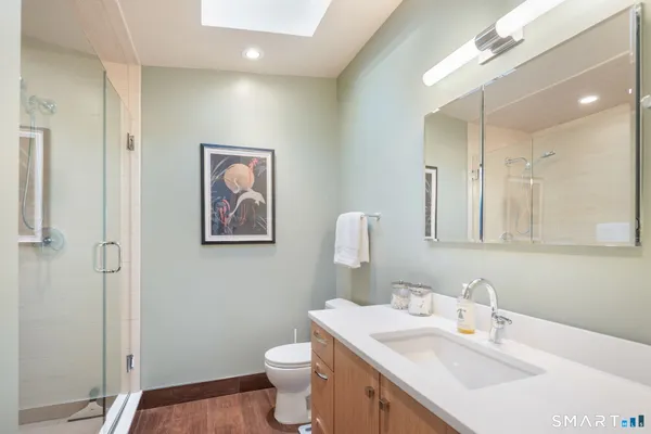 a bathroom with a sink toilet and shower