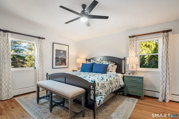 a bedroom with a bed and wooden floor
