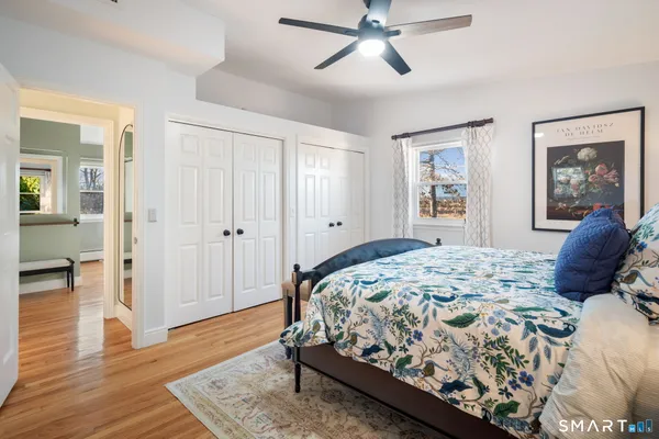 a bedroom with a large bed and a window