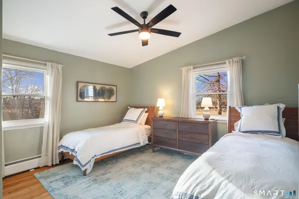 a bedroom with a bed and a large window