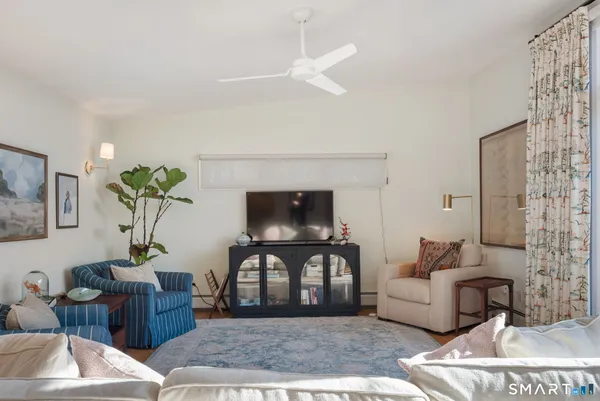a living room with furniture and a potted plant