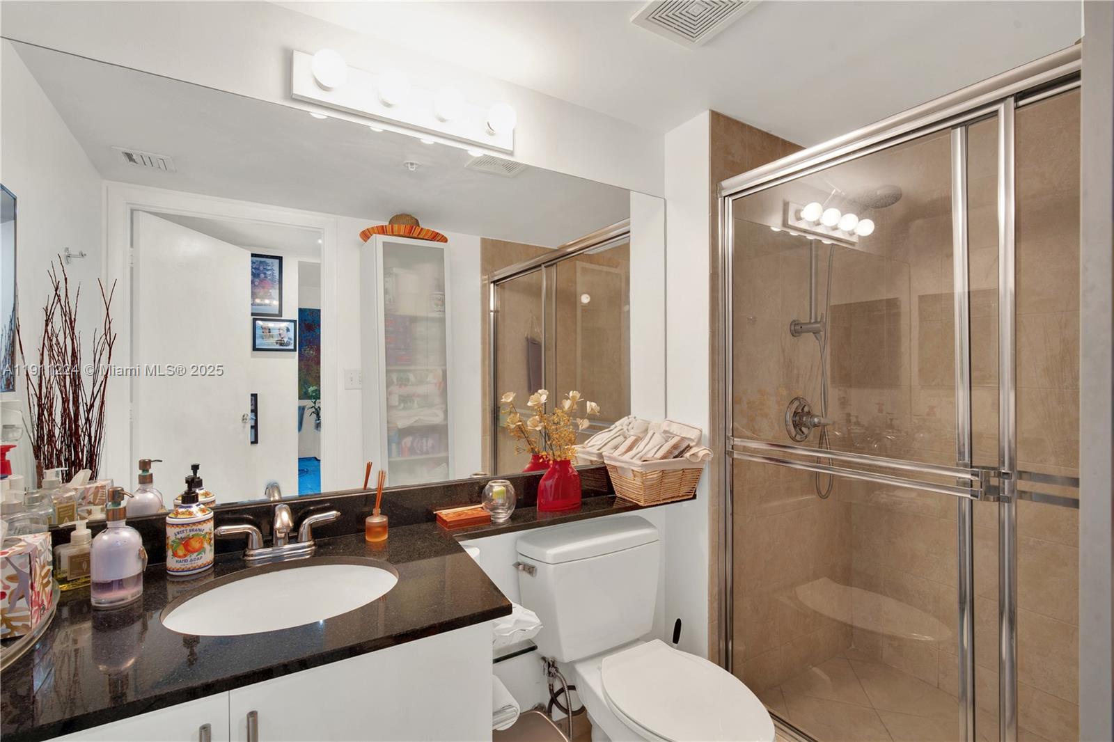 31 Southeast 5th Street, Unit 2910 Miami, FL 33131 - Photo 23 of 34 a bathroom with a sink toilet and shower