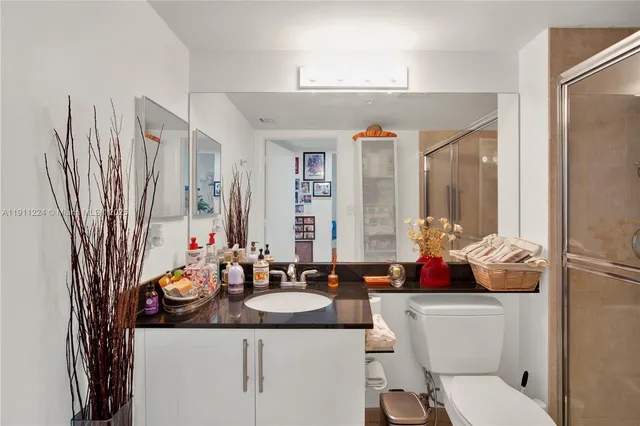 a kitchen with granite countertop a sink and cabinets