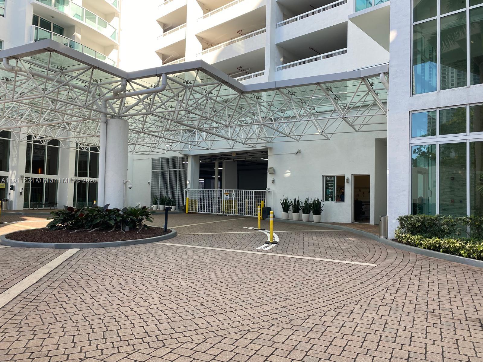 31 Southeast 5th Street, Unit 2910 Miami, FL 33131 - Photo 30 of 34 a front view of a building with a garden and plants