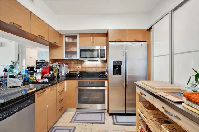 a kitchen with a refrigerator and a sink