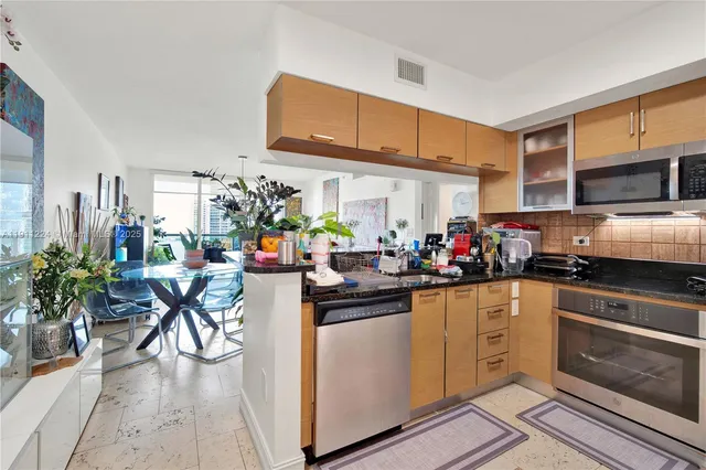 a kitchen with lots of counter top space and wooden floor