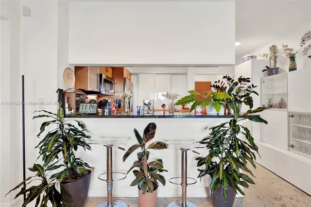 a living room with furniture potted plant and a flat screen tv