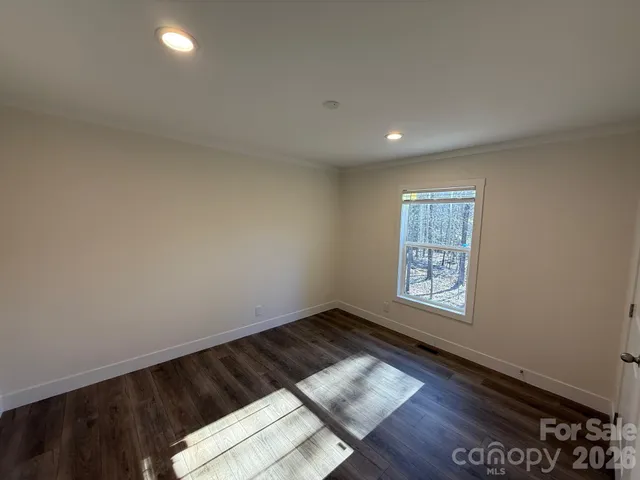 a view of wooden floor and windows in a room