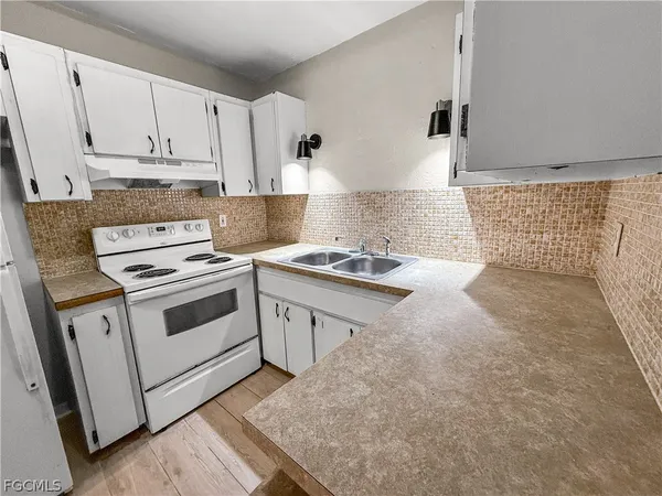 a view of kitchen with refrigerator and wooden floor