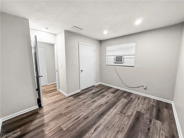 a view of room with wooden floor