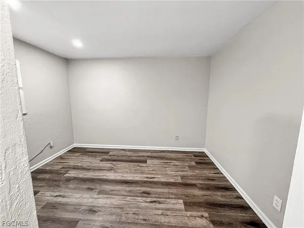 a view of room with wooden floor