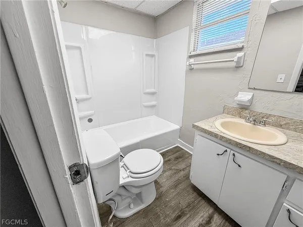 a white toilet sitting next to a bathroom sink and tub
