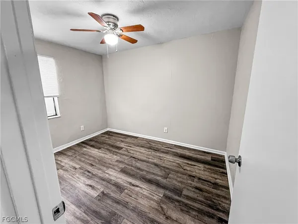 a view of a room with wooden floor