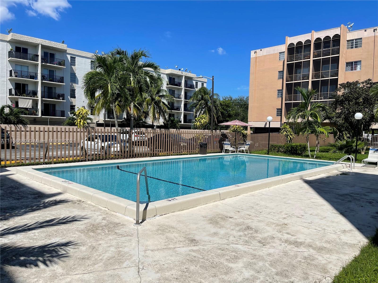 4670 West 13th Lane, Unit 210 Hialeah, FL 33012 - Photo 3 of 11 a view of a swimming pool with a patio