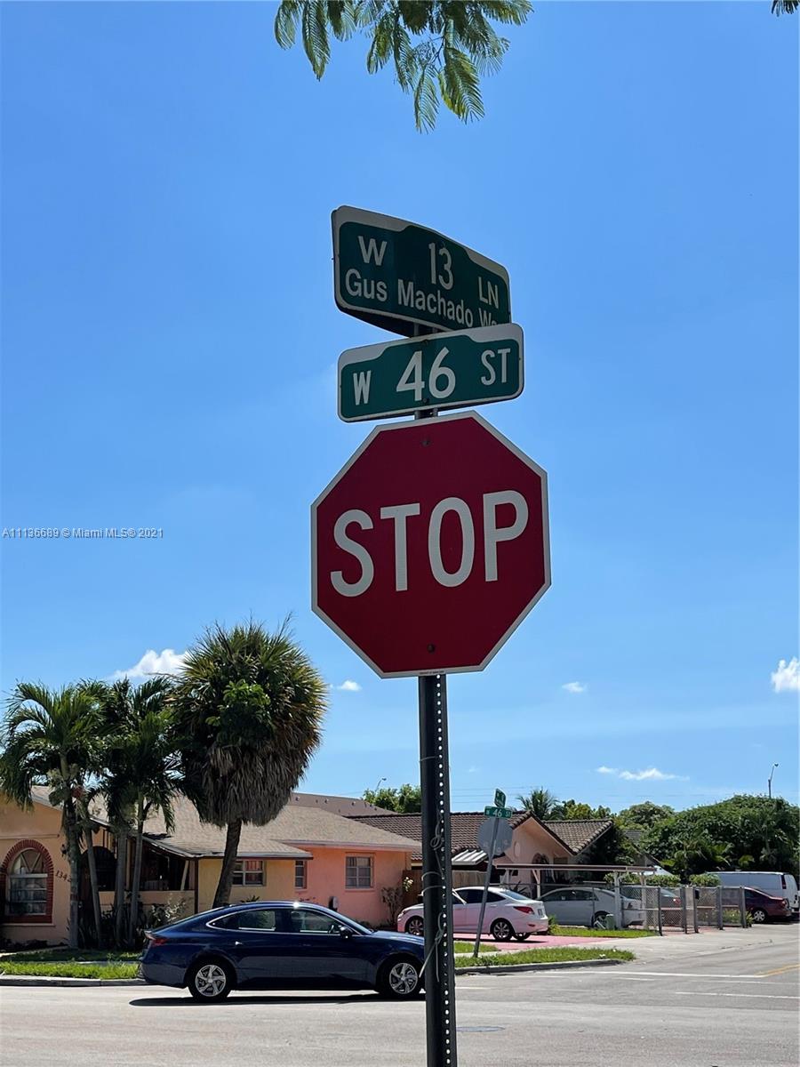 4670 West 13th Lane, Unit 210 Hialeah, FL 33012 - Photo 9 of 11 a street sign on a pole on a street