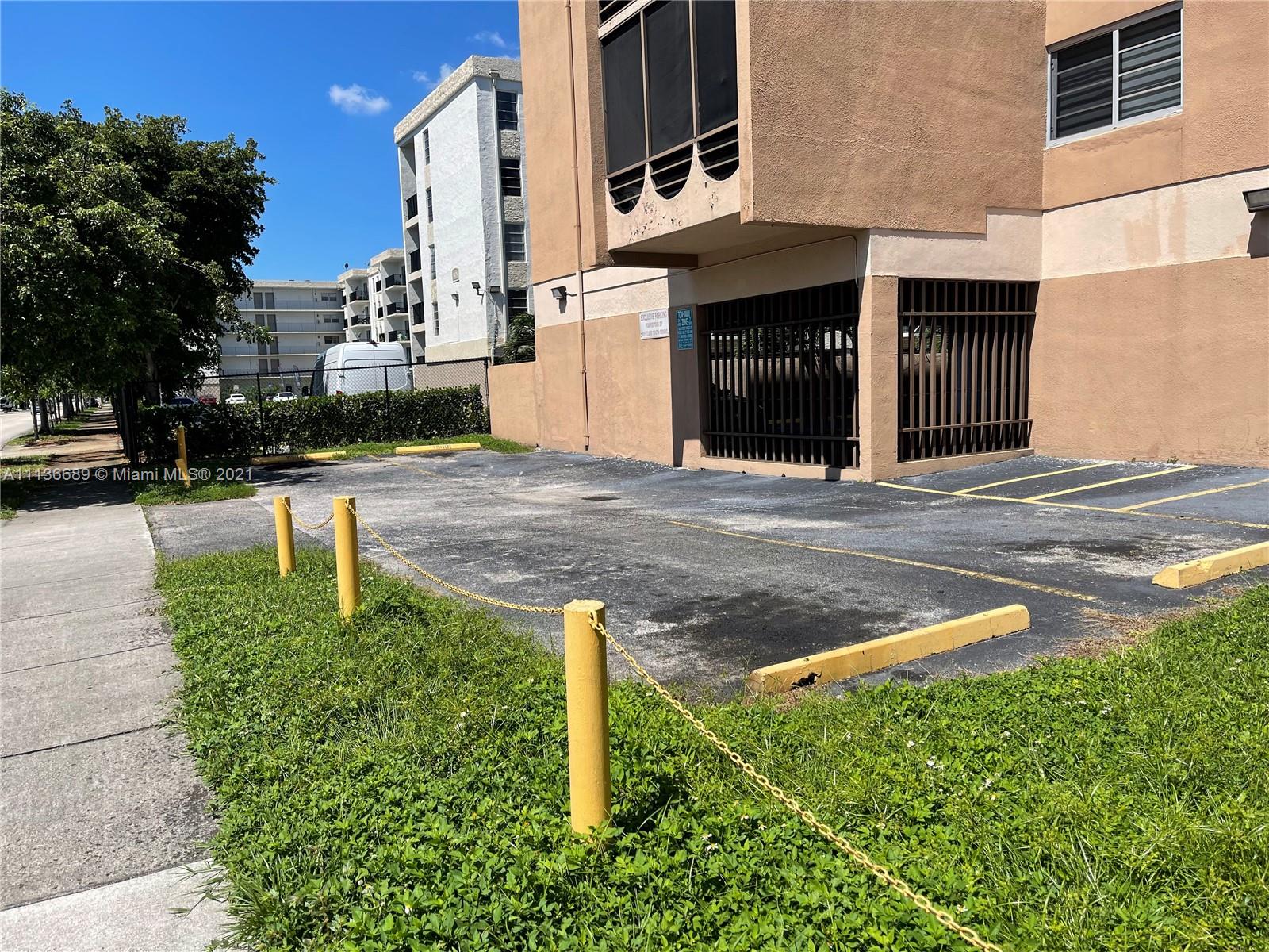 4670 West 13th Lane, Unit 210 Hialeah, FL 33012 - Photo 10 of 11 a front view of a building with garden