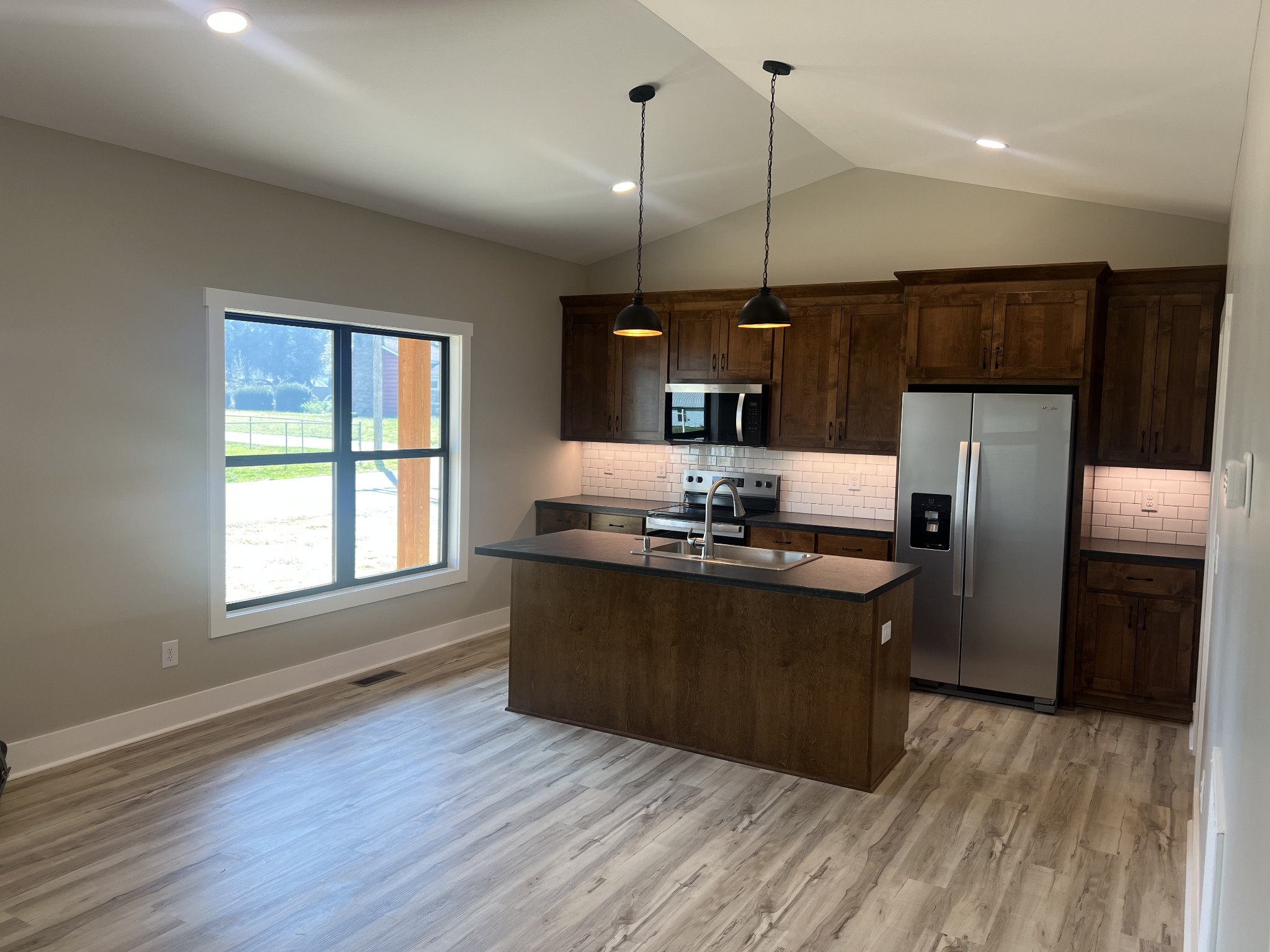 401 Hawkins Street Cowan, TN 37318 - Photo 3 of 15 a kitchen with kitchen island a sink appliances a counter space and a window
